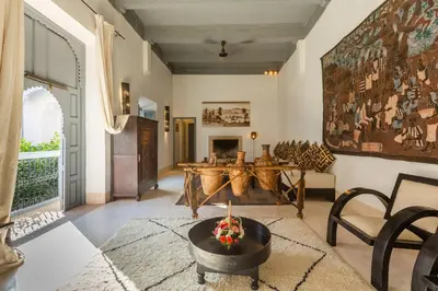 a living room with a table and a fireplace at Riad Tchaikana in Marrakech