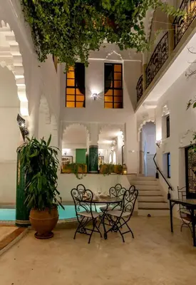 a room with a table and chairs in a building at Riad Hart Essoura in Marrakech