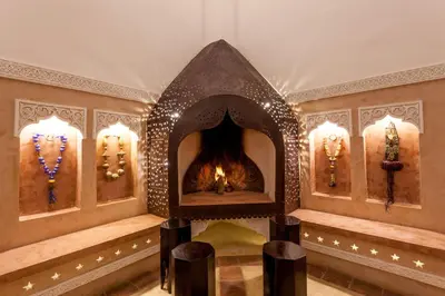 a room with a fireplace in a building at Riad Hart Essoura in Marrakech