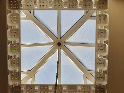 a large window in a room with a ceiling at Riad BAB ALMADINA in Marrakech