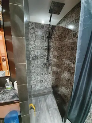 a bathroom with a shower with a shower curtain at Charming Marrakech Apartement in Marrakech