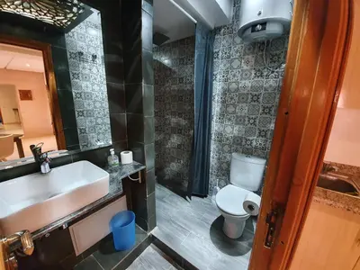 a bathroom with a white toilet and a sink at Charming Marrakech Apartement in Marrakech