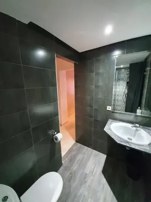 a bathroom with a sink and a toilet and a mirror at Charming Marrakech Apartement in Marrakech