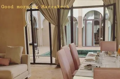a dining room with a table and a couch at Villa Mayrit, Villa estilo Riad en un entorno único in Marrakech