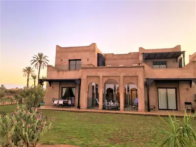 a large house in the middle of a field at Villa Mayrit, Villa estilo Riad en un entorno único in Marrakech