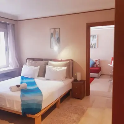 a bedroom with a bed with white sheets and pillows at Appartement Patio centre Gueliz in Marrakech