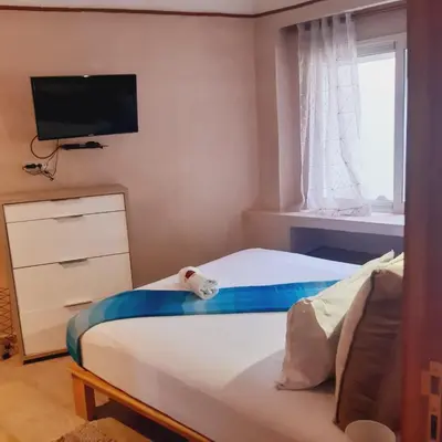 a bedroom with a bed with a tv on the wall at Appartement Patio centre Gueliz in Marrakech