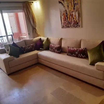 a couch with pillows on it in a living room at Appartement Patio centre Gueliz in Marrakech