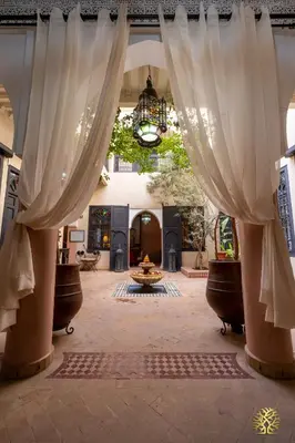 an open hallway with white curtains in a building at Riad Saba in Marrakech