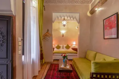 a living room with a couch and a bed at Riad Saba in Marrakech