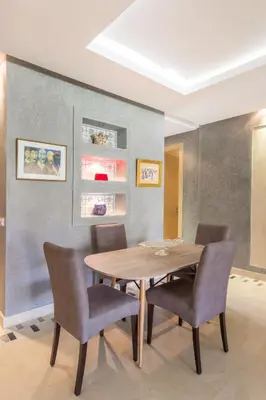 a dining room with a wooden table and chairs at Pool View With Garden in Prestigia - WIFI & Pool in Marrakech
