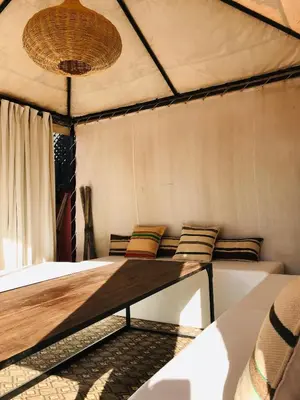 a room in a tent with two beds at riad anrich in Marrakech
