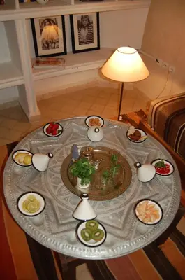 a table with plates of food on top of it at riad anrich in Marrakech