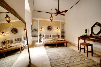 a bedroom with two beds and a piano at Riad Mazarin des gourmets in Marrakech