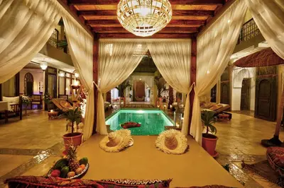 a swimming pool in a room with a ceiling at Riad Mazarin des gourmets in Marrakech