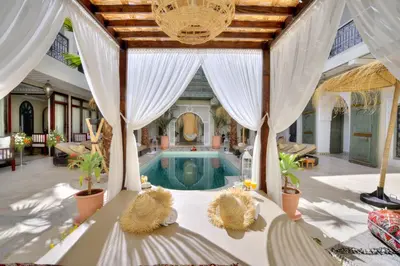 a house with a pool in the middle of a room at Riad Mazarin des gourmets in Marrakech