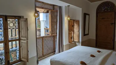 a bedroom with a bed and an open window at Riad Dar Eternity in Marrakech