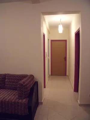 a living room with a couch and a hallway at Appartement Aïda in Marrakech