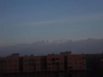 a group of buildings with mountains in the background at Appartement Aïda in Marrakech