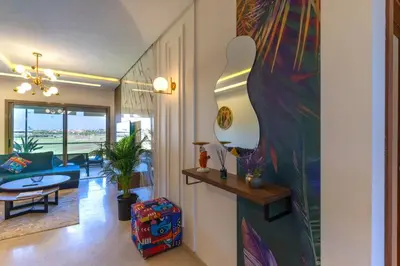 a living room with a large painting on the wall at Cozy Golf Apartment Wifi 4k-TV Netflix in Marrakech