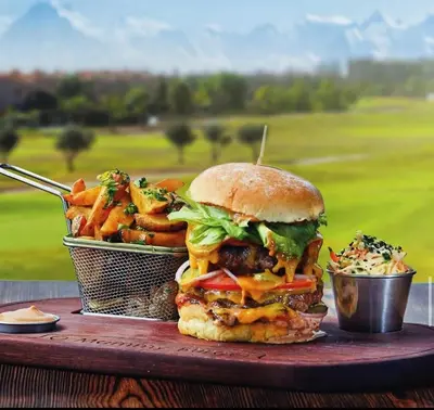a sandwich and fries on a table with a basket of food at Cozy Golf Apartment Wifi 4k-TV Netflix in Marrakech