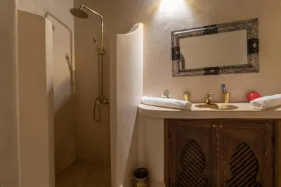 a bathroom with a sink and a mirror at Riad dar El Arsa Rooftop & jacuzzi in Marrakech