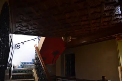a room with a ceiling and stairs with a flag at Riad Hôtel Belleville Marrakech in Marrakech