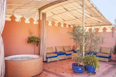 aentedented patio with a hot tub in a tent at Riad La Kahana in Marrakech