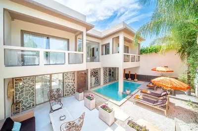 an exterior view of a house with a swimming pool at Villa White High-Standing - Breakfast in Marrakech