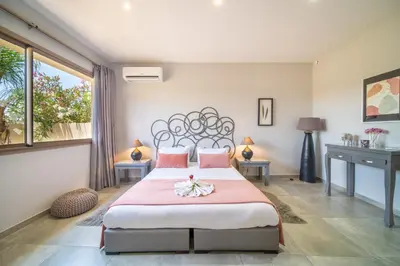 a bedroom with a large bed with a pink blanket at Villa White High-Standing - Breakfast in Marrakech