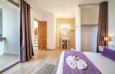 a bedroom with a bed with a purple bedvisor at Villa White High-Standing - Breakfast in Marrakech