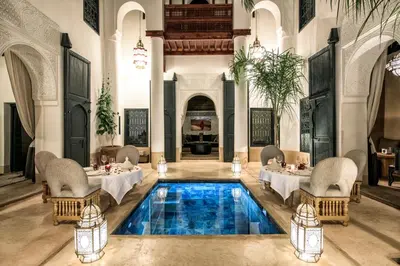 a restaurant with a pool in the middle of a room at Dar Assiya in Marrakech