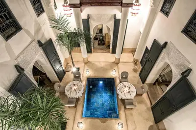 an overhead view of a swimming pool in a building at Dar Assiya in Marrakech