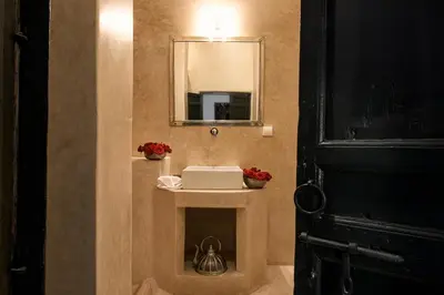 a bathroom with a sink and a mirror at Dar Assiya in Marrakech