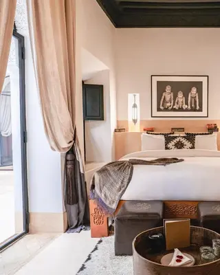 a bedroom with a large bed and a large window at Dar Assiya in Marrakech