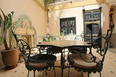a dining room with tables and chairs in a building at RIAD MAKENE MOUCHKILL in Marrakech