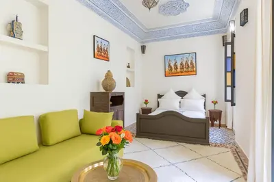 a living room with a couch and a bed at Riad 111 & Spa in Marrakech