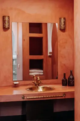 a bathroom sink with a large mirror above it at Riad ANYSSA in Marrakech