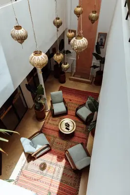 an overhead view of a living room with chairs and a rug at Riad ANYSSA in Marrakech