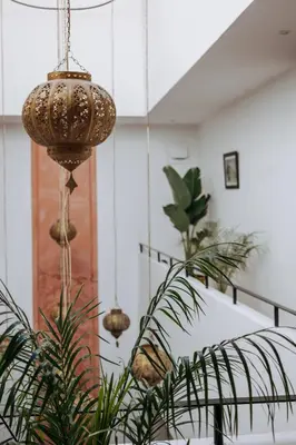 a room with a staircase with potted plants at Riad ANYSSA in Marrakech