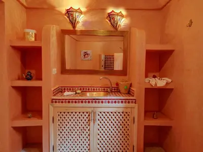 a bathroom with a sink and a mirror at Riad Princesse Du Désert & Spa in Marrakech