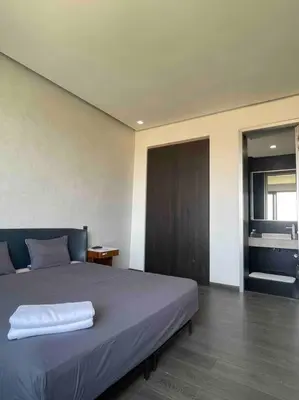 a bedroom with a bed with a white towel on it at Luxury Palm Villa in Marrakech
