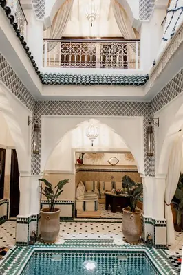 a large room with a swimming pool in front of a house at Riad Art & Emotions in Marrakech