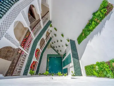 a view of the courtyard of a mosque with plants at Riad Art & Emotions in Marrakech