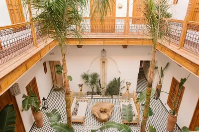 an overhead view of a room with palm trees and a table at Riad Le Pèlerin in Marrakech