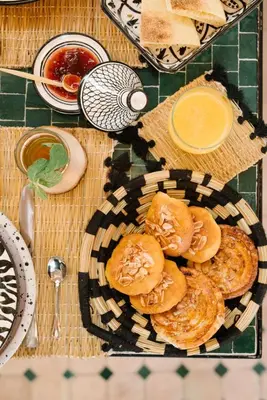 a plate of pastries sitting on a table at Riad Le Pèlerin in Marrakech