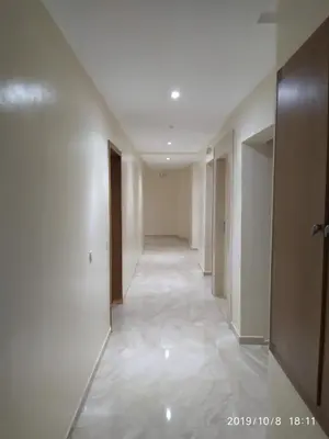 an empty hallway with white walls and a hallway with doors at Opéra Appartement, Hivernage Marrakech. in Marrakech