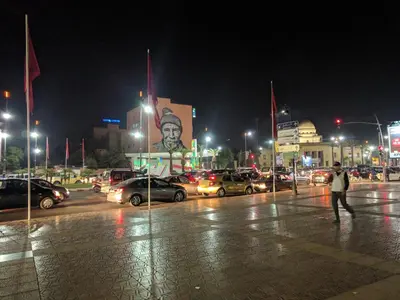 a man walking in a parking lot at night at Opéra Appartement, Hivernage Marrakech. in Marrakech