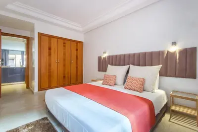 a bedroom with a large bed with a red blanket at Best for group, 5 min from medina in Marrakech