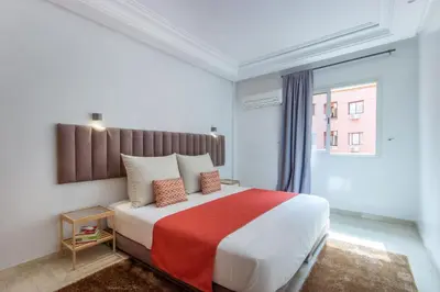 a bedroom with a large bed with a red blanket at Best for group, 5 min from medina in Marrakech